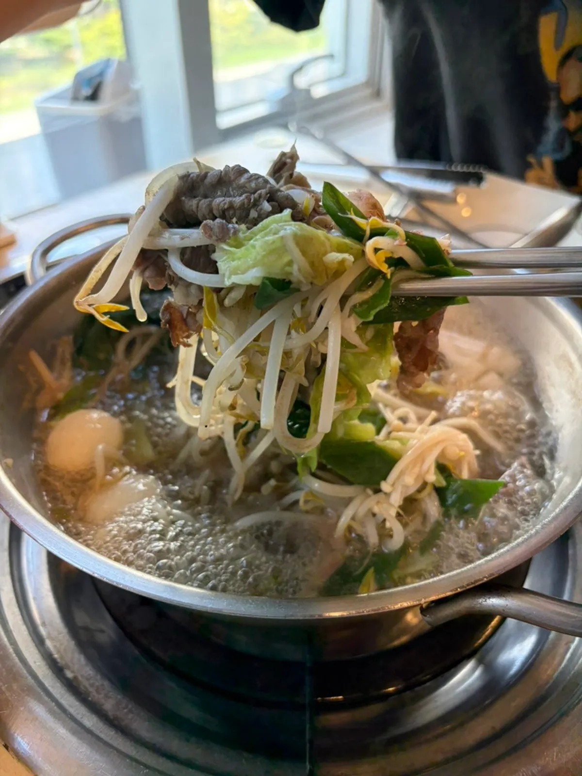 Shabu-shabu pot boiling with plenty of ingredients