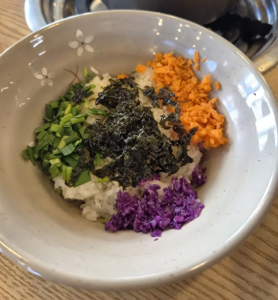 A bite of kalguksu noodles with napa cabbage kimchi