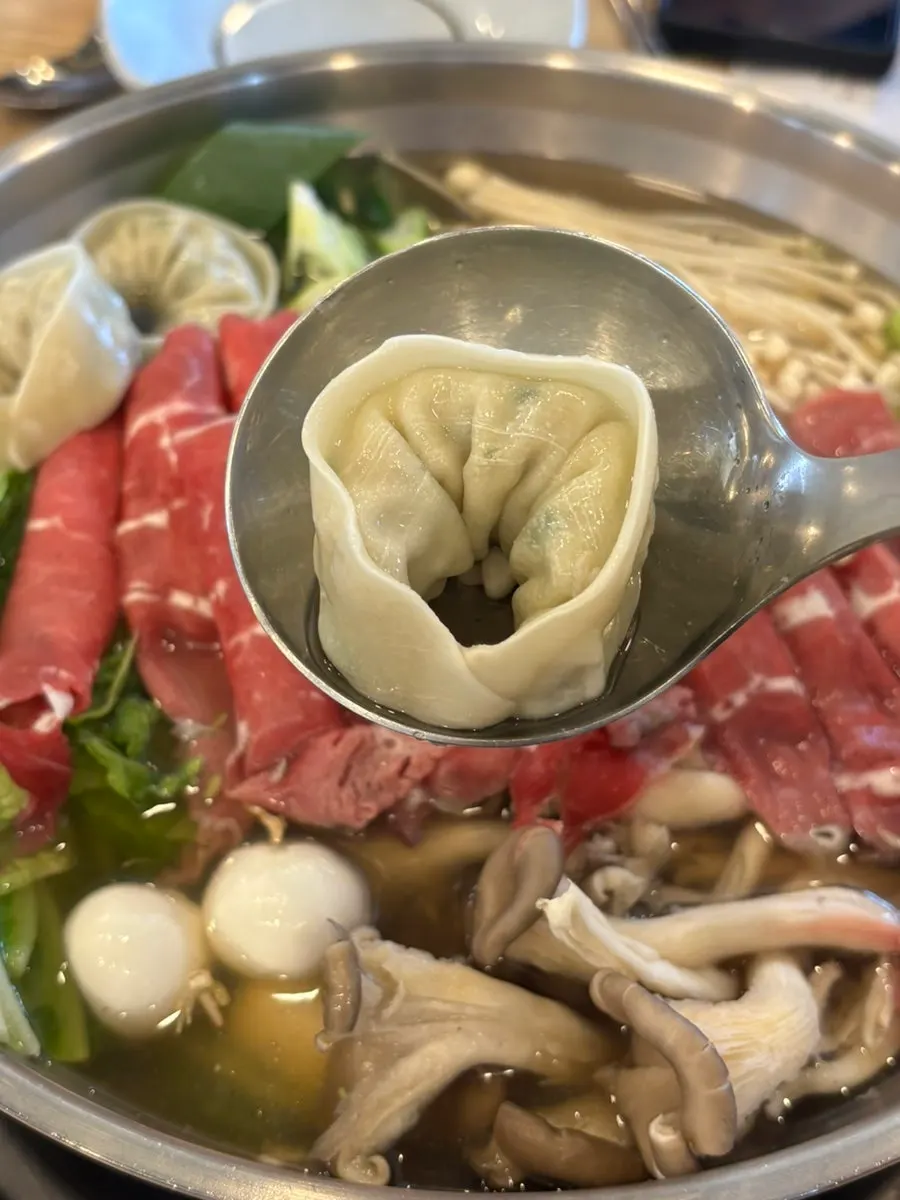 Plate loaded with shabu vegetables and mushrooms