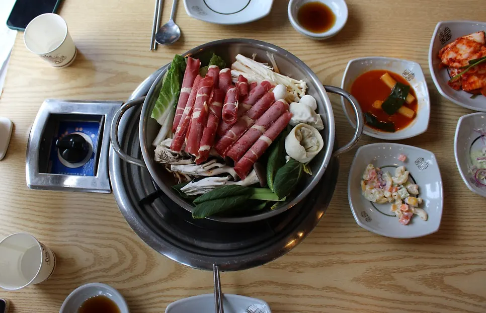 Table set with shabu kalguksu and seafood pajeon