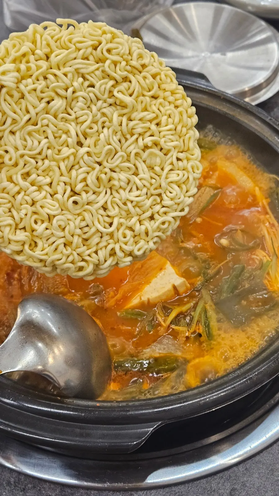 Enoki mushrooms added to the stew