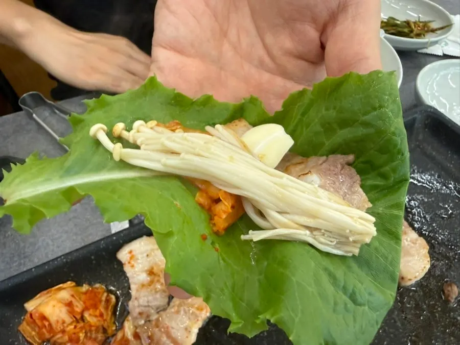 Pork belly eaten in a wrap