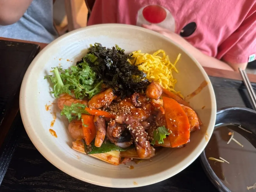 Soup and noodles drizzled with dressing