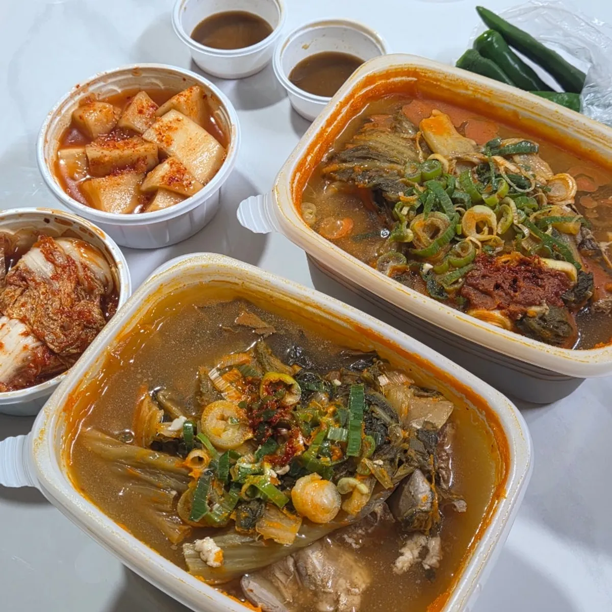 A bowl of pork bone soup with three large bone pieces
