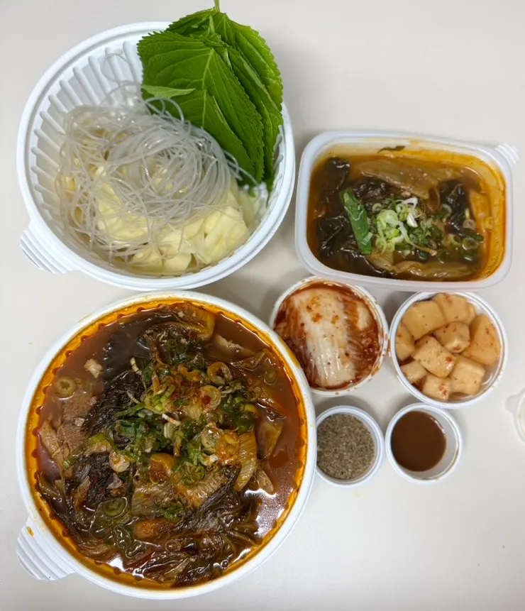 Takeout gamjatang packed with separate side containers