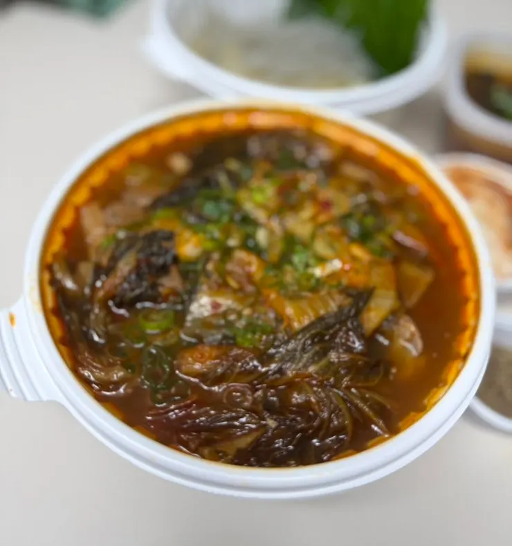 Container with perilla leaves, dumplings and glass noodles