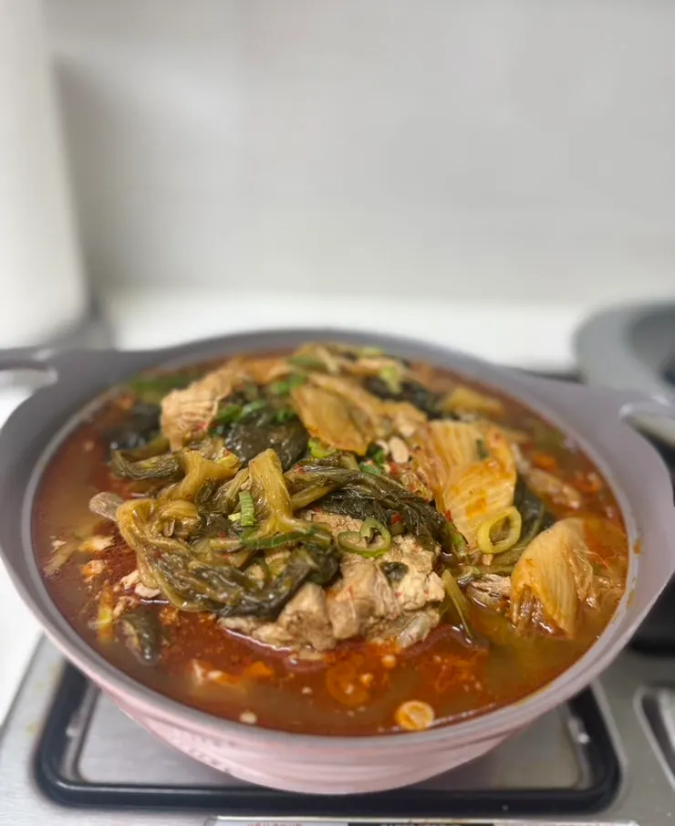 Gamjatang broth made spicier with added chili flakes