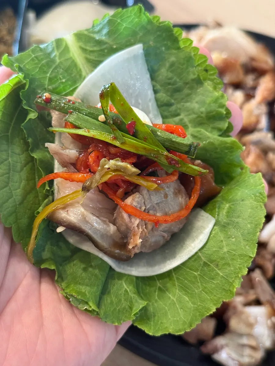 Jokbal wrap made with lettuce and perilla leaves