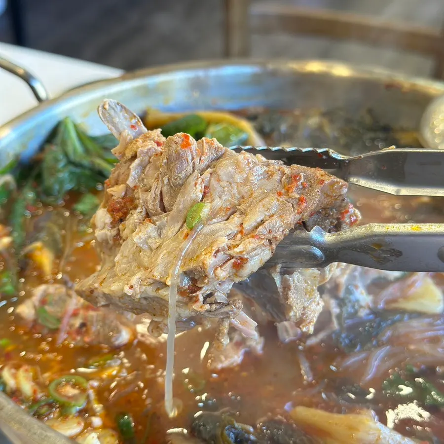 Gamjatang hot pot topped with perilla leaves