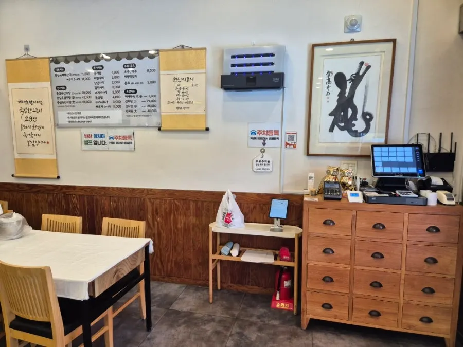 Restaurant interior with tiled-roof decor and paintings