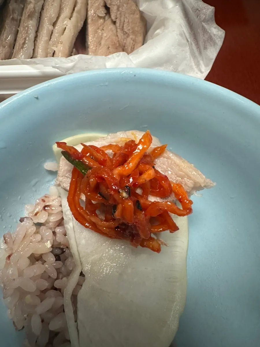 Bossam and side dishes on a lettuce leaf
