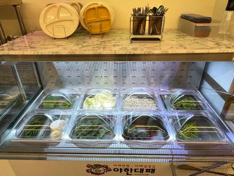 Self-serve bar with mushrooms, sweet pumpkin, bean sprouts, and bracken fern