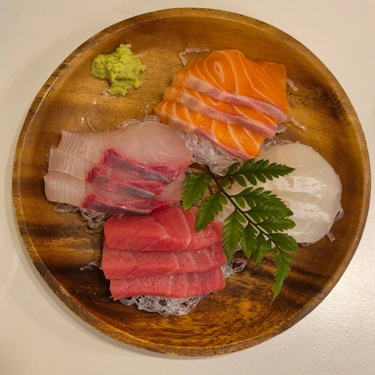 12 pieces of sashimi per person with yellowtail, salmon, and tuna