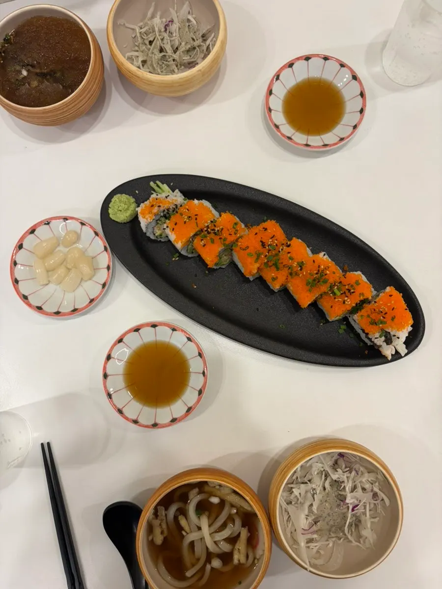 A plate of California roll topped with salmon roe