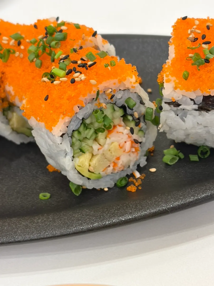 Cross-section of California roll with crab stick, egg, and cucumber