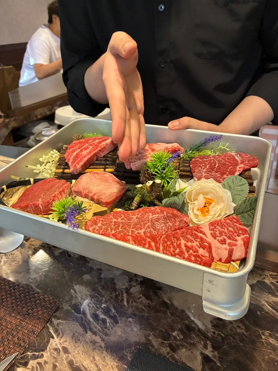 Raw meat cuts shown by staff before ordering