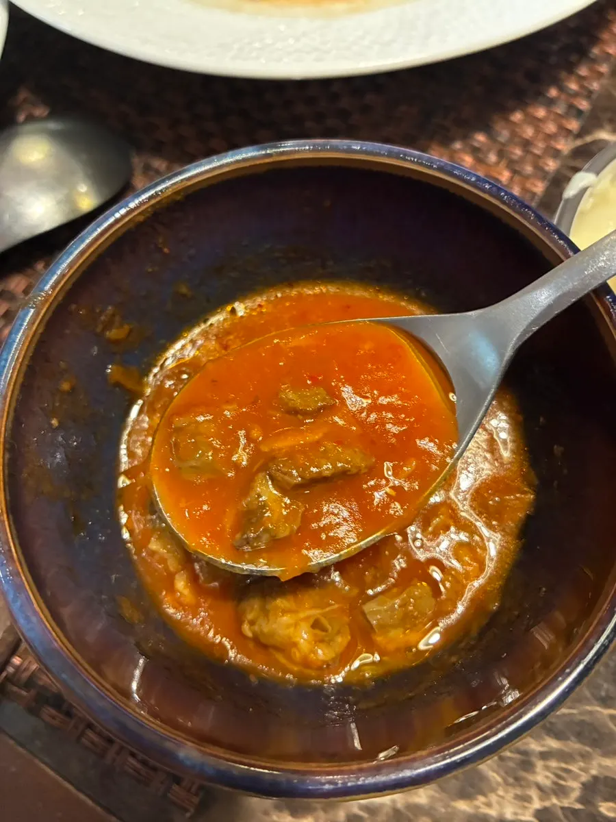 A bowl of tomato beef stew