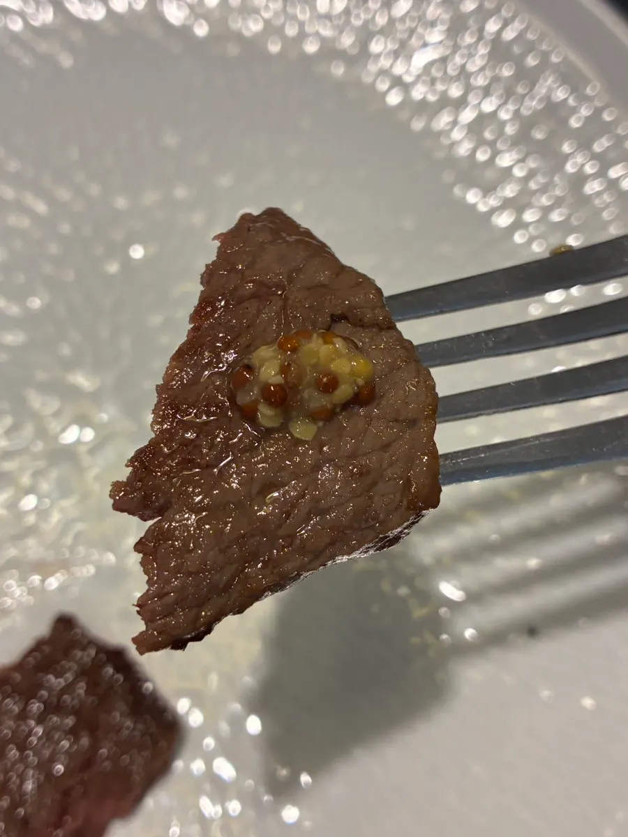 A bite of steak seasoned simply with salt