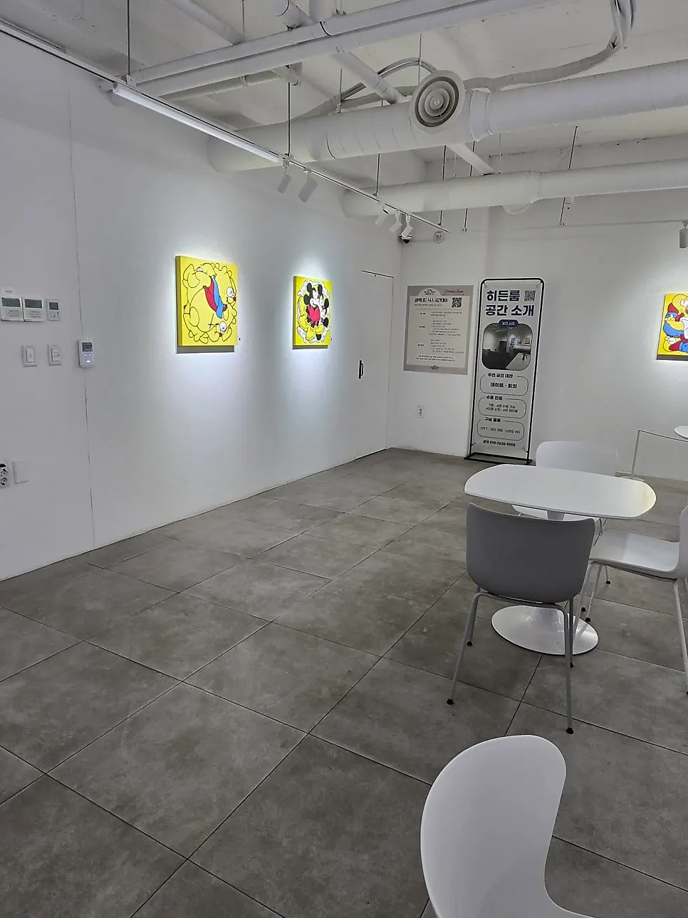 Artist's work exhibited on a white wall