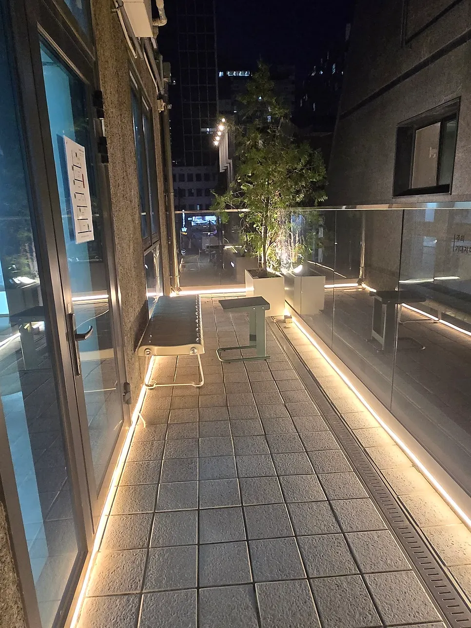Nighttime balcony with continuous floor lighting