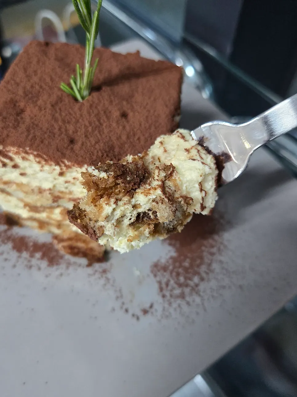 Cross-section of tiramisu scooped with a spoon