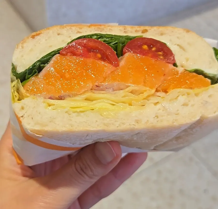 Coffee served alongside a sandwich spread