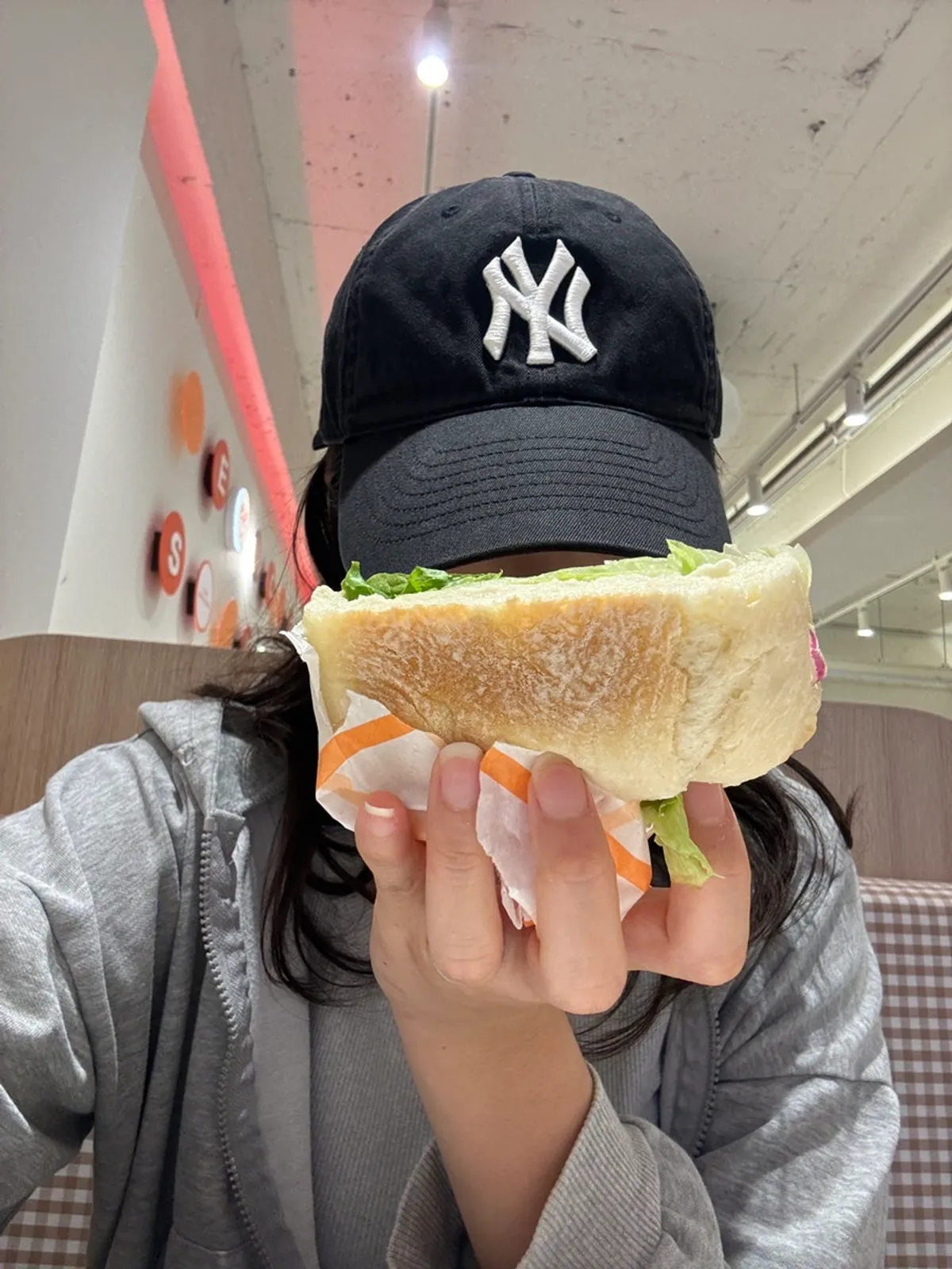 Smoked salmon sandwich held up to show its size