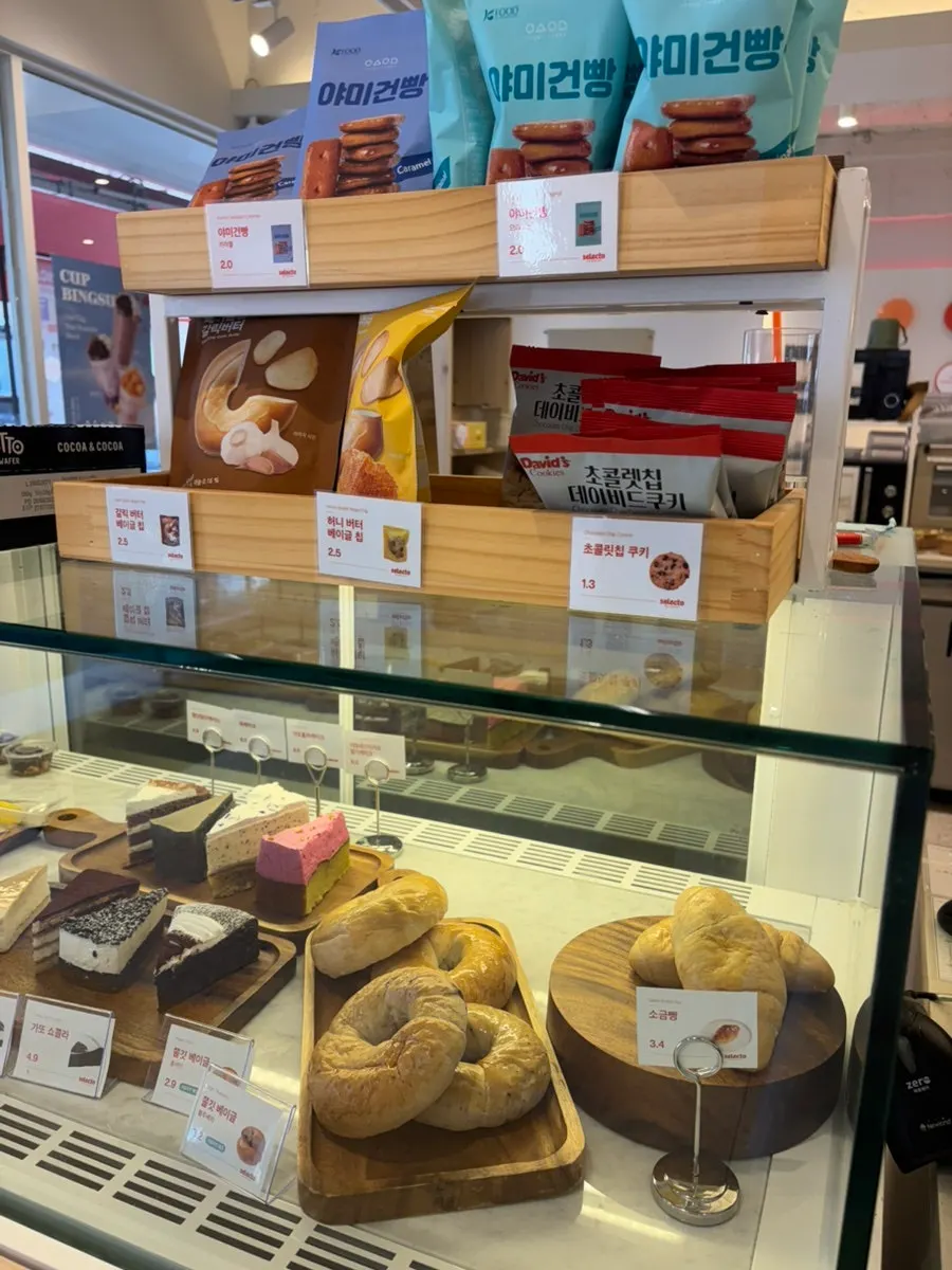 Display case with cakes and sandwiches
