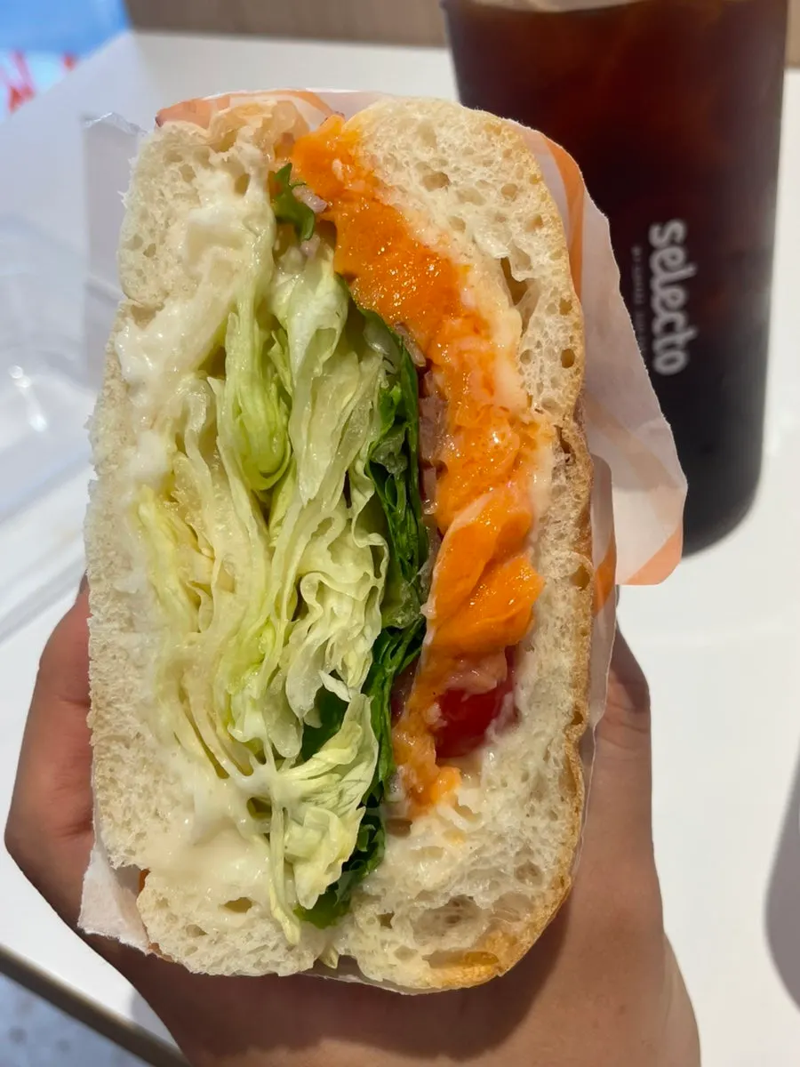 Sandwich showing smoked salmon and cherry tomatoes