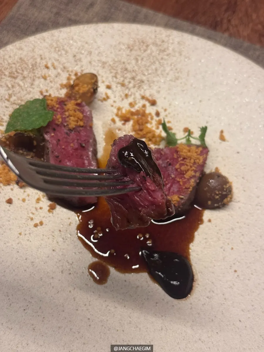 Striploin steak with black garlic purée and potato crumble