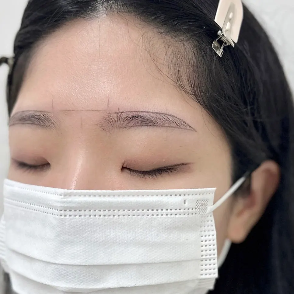 Completed semi-permanent eyebrows in gray