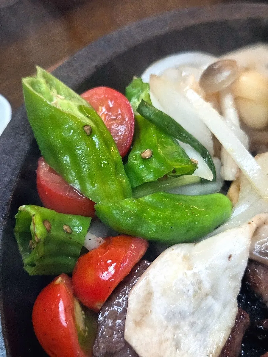 Meat served with mushroom and cheongyang pepper garnish