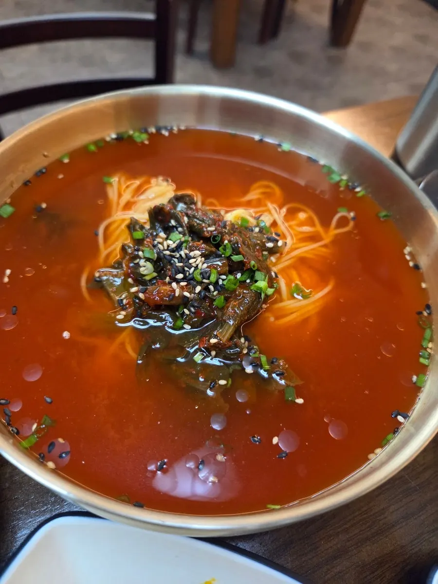 A bowl of gat kimchi noodle soup