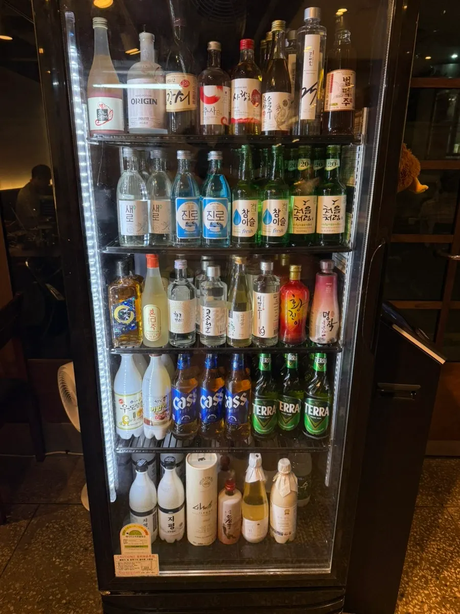 Liquor fridge stocked with various drinks