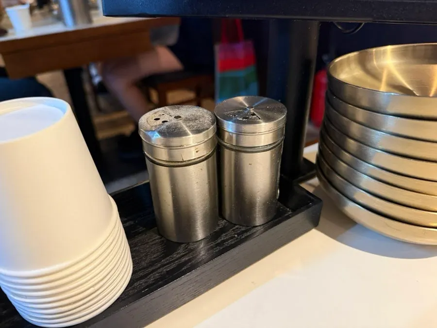 Table set with disposable apron and salt and pepper
