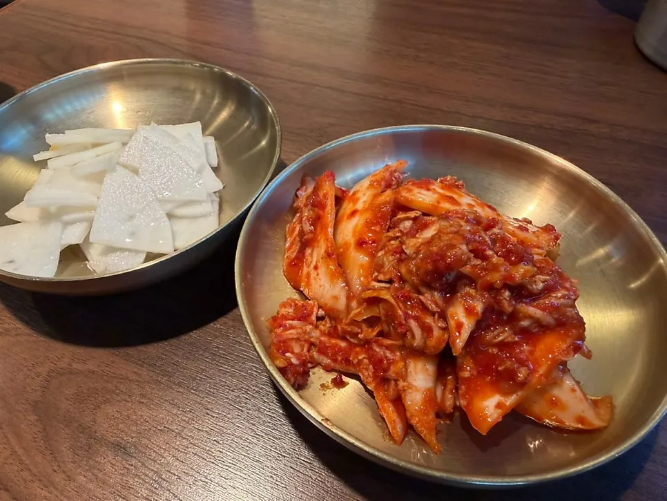 Table set with chogyeguksu, boneless dakbokkeumtang, and chicken muchim