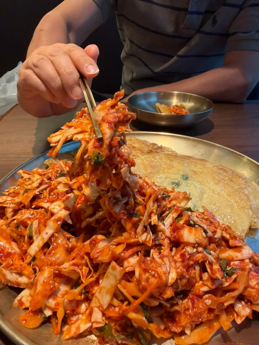 Chicken muchim piled on top of flat mandu