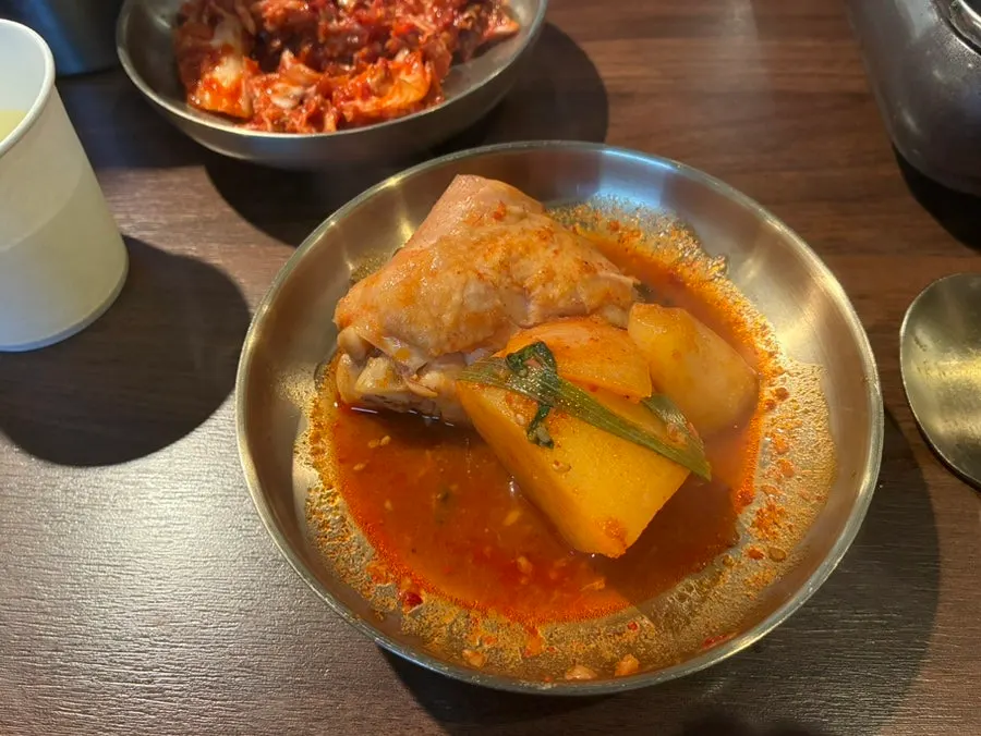Holding up a piece of chicken breast from the dakbokkeumtang