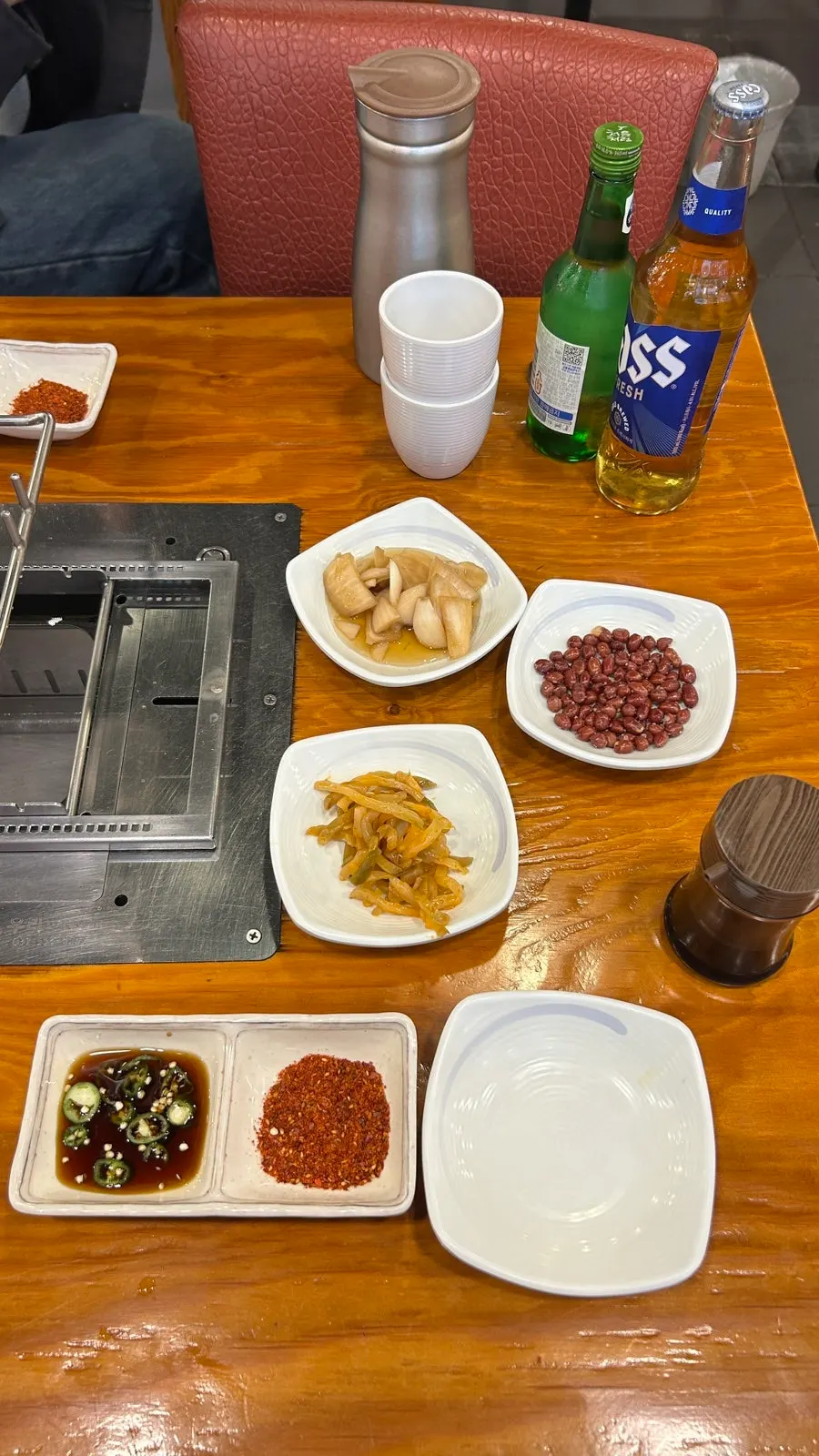 Basic side dishes of peanuts, pickled mustard greens, pickled radish, and cumin powder