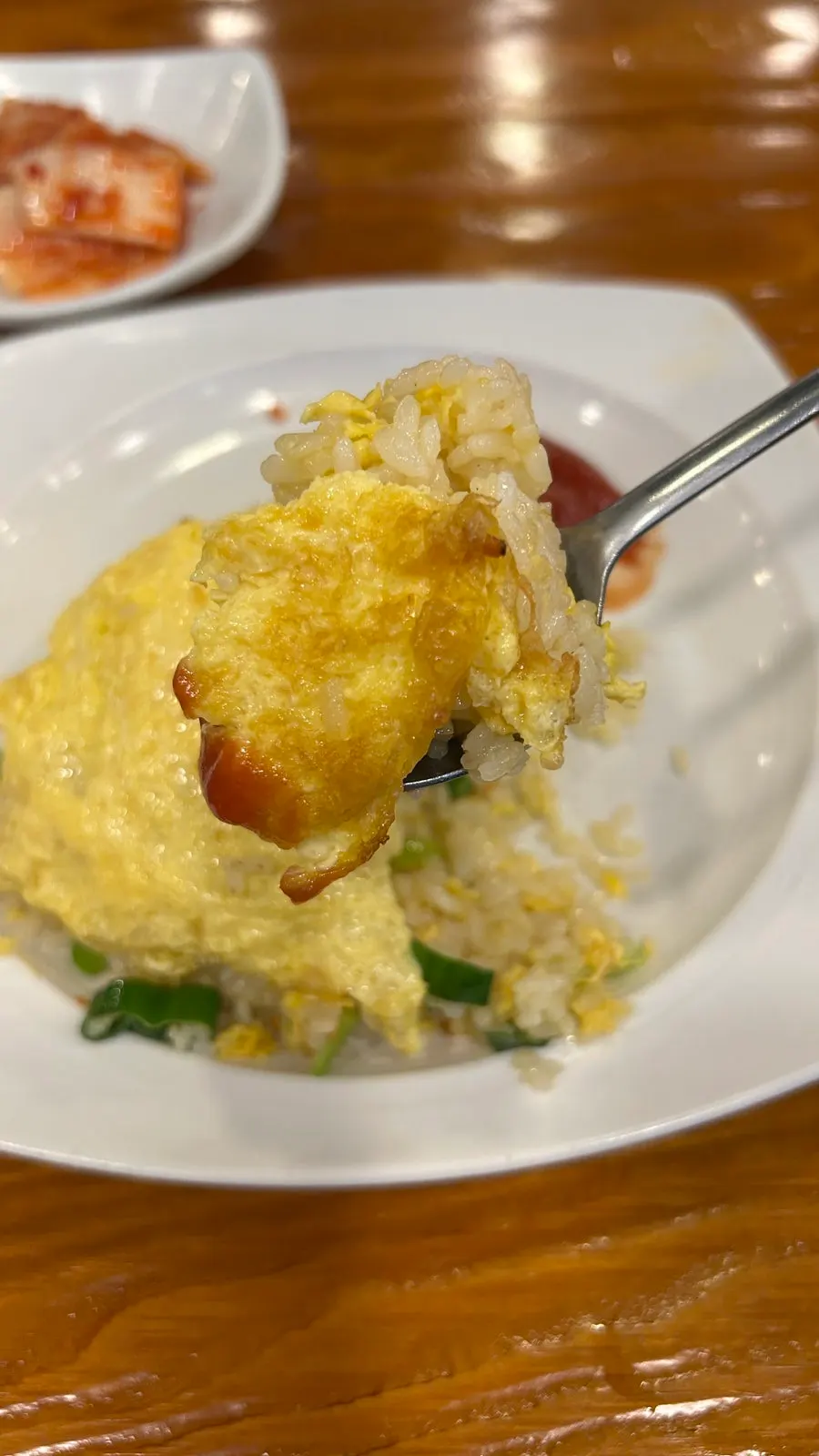Fried rice topped with egg and served with ketchup