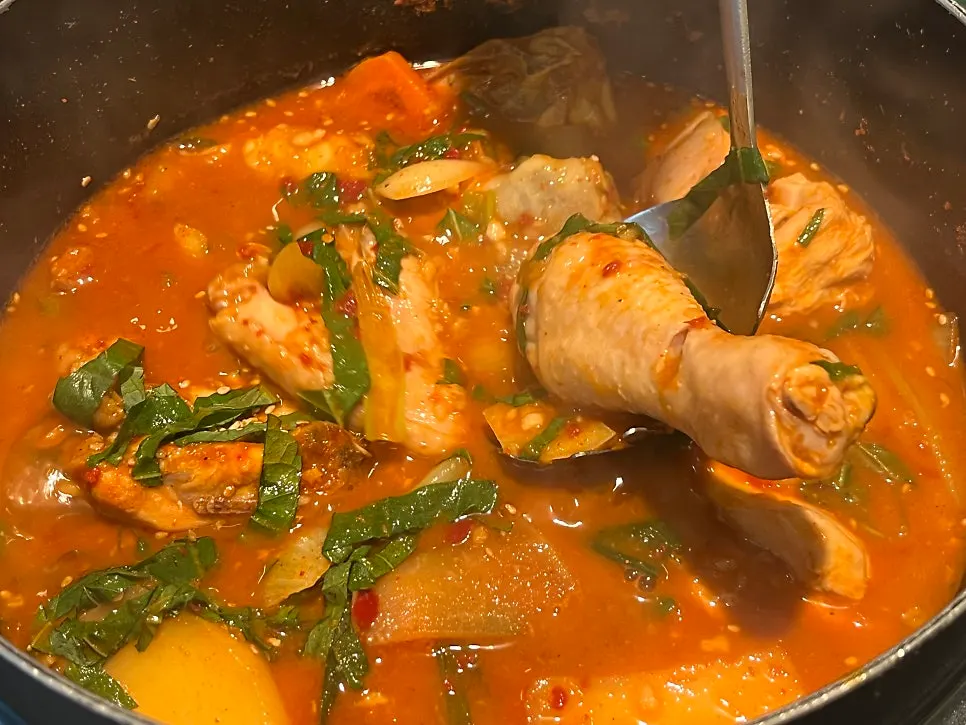 Chicken pieces soaked in gochujang sauce in the dakbokkeumtang