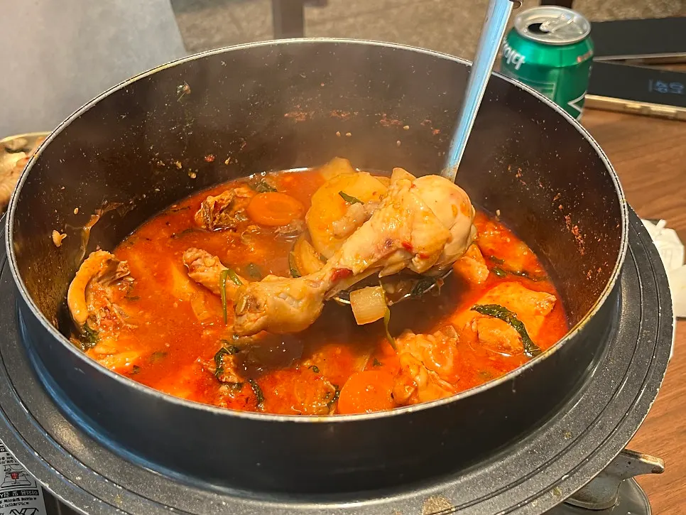 A piece of dakbokkeumtang chicken falling off the bone