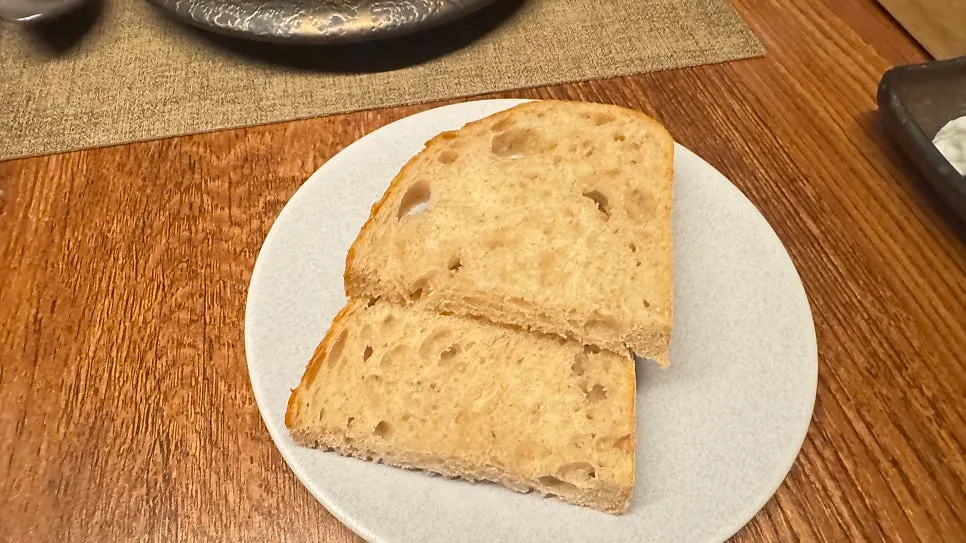 Warm sourdough bread served mid-course