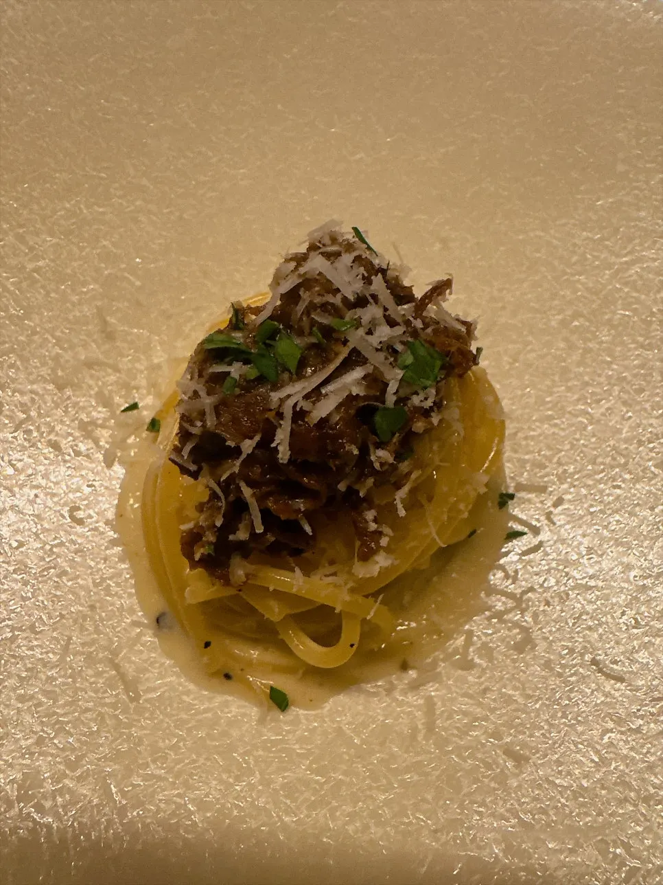 White Genovese-style pasta topped with cheese