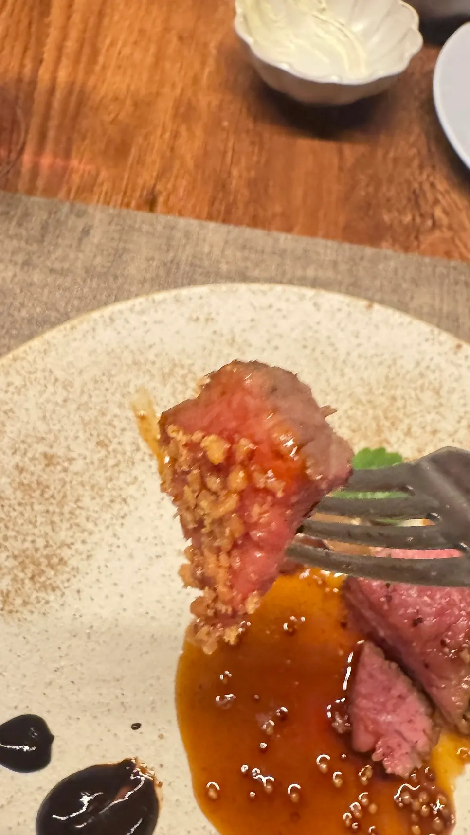 Striploin steak plated with balsamic mini onions