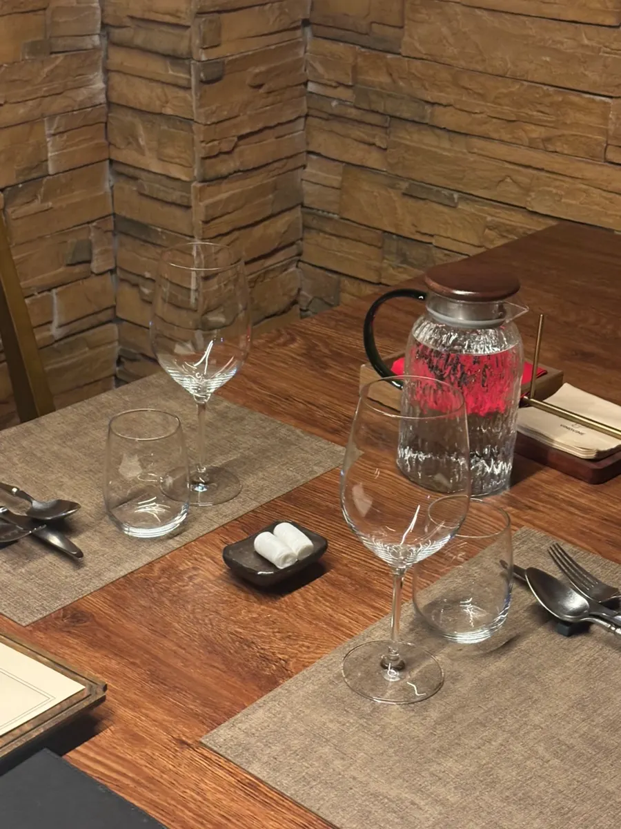 A table at Vinovine set with cutlery and a wine glass