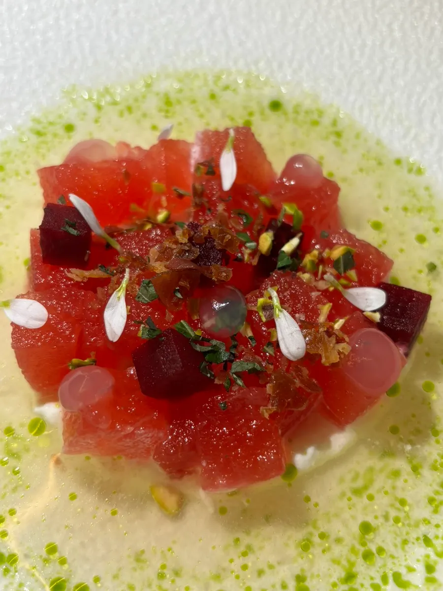 Smoked watermelon appetizer with stracciatella and tomato water