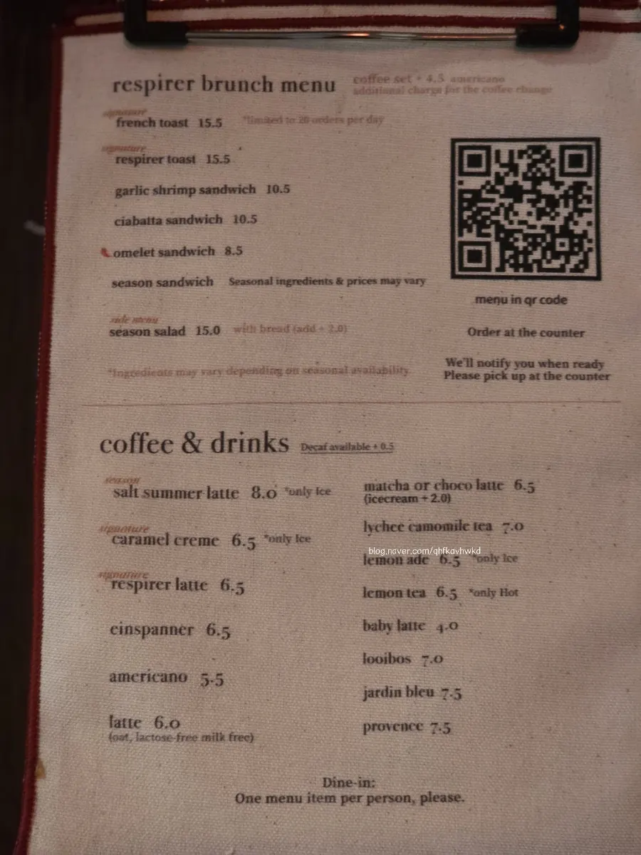 Menu board listing signature drinks and decaf options