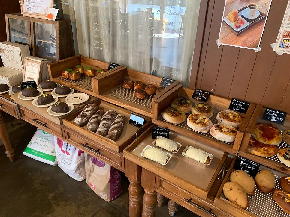 Bakery display case with salt bread and chocolate baguette