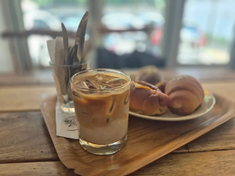 Three types of salt bread and an iced latte on the table